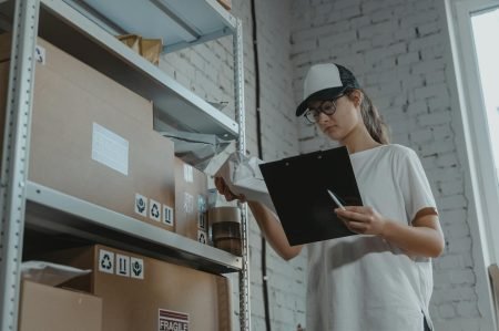 Woman in White T-shirt Holding Black Laptop Computer